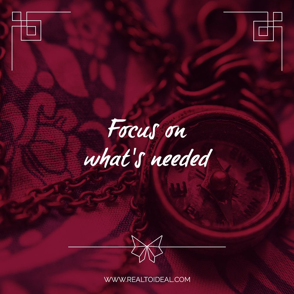 red photo of a compass and its chain draped across a blanket with the words Focus on what's needed written across the middle and the Real To Ideal branding decor.