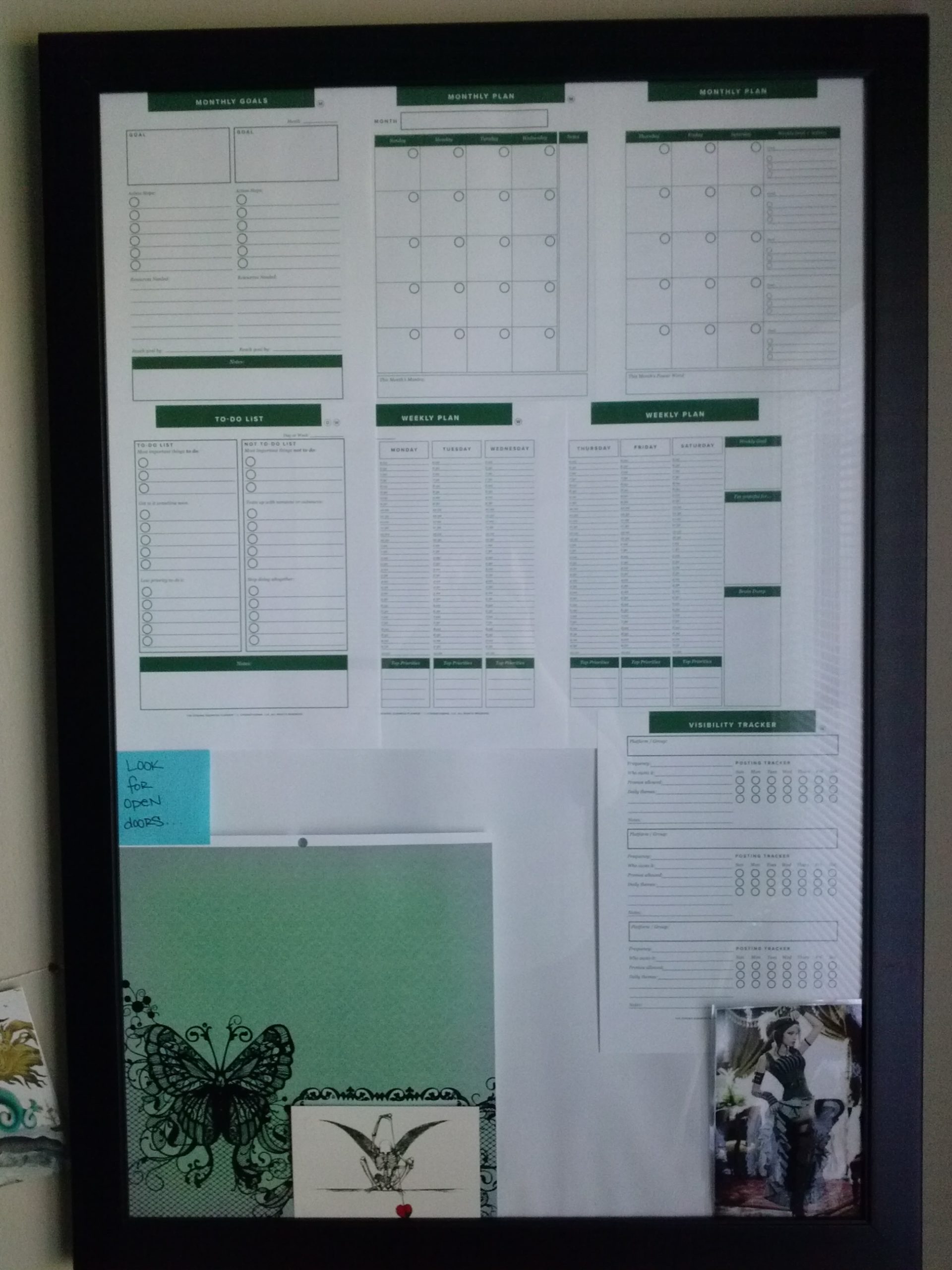 blank calendar for goal planning spread out inside a picture frame and used as a wipe-off board